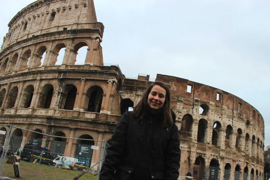standing in front of the colosseum in rome italy