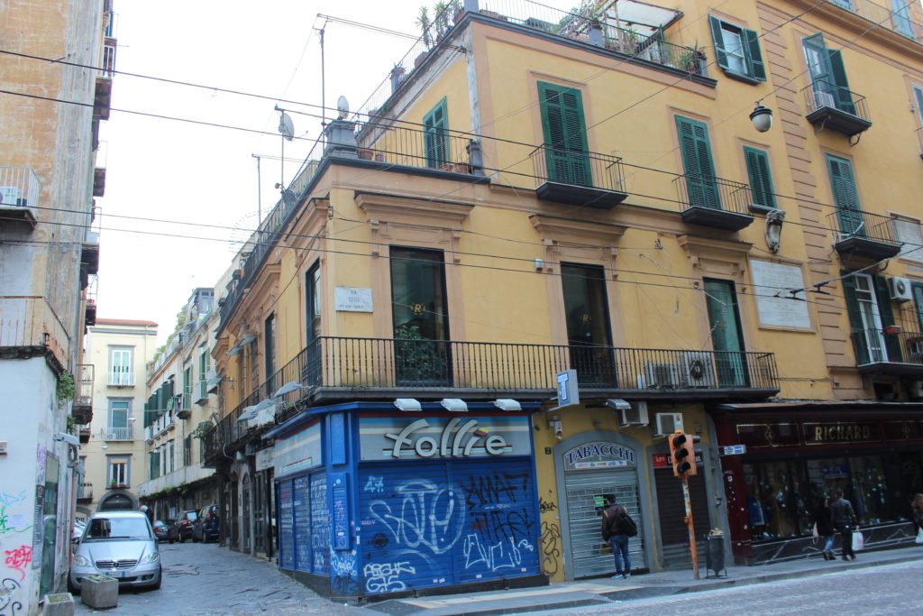 street with yellow building and graffiti in naples italy