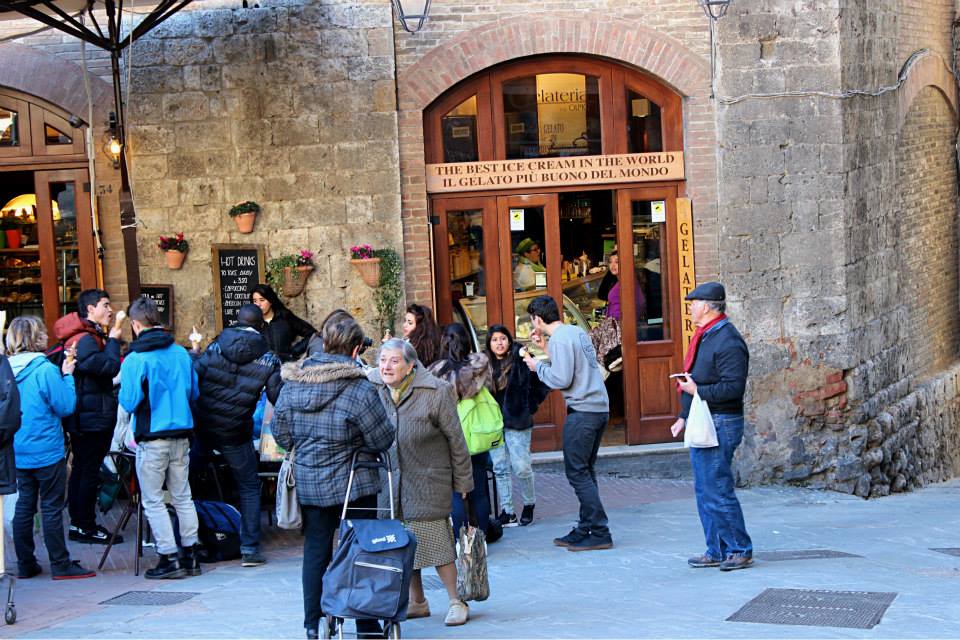 locals outside a gelataria in san gimignano eating the best gelato in italy