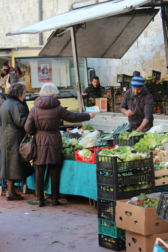 locals at a street market in italy