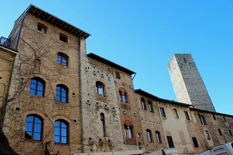 view of stone buildings of san gimignano from below