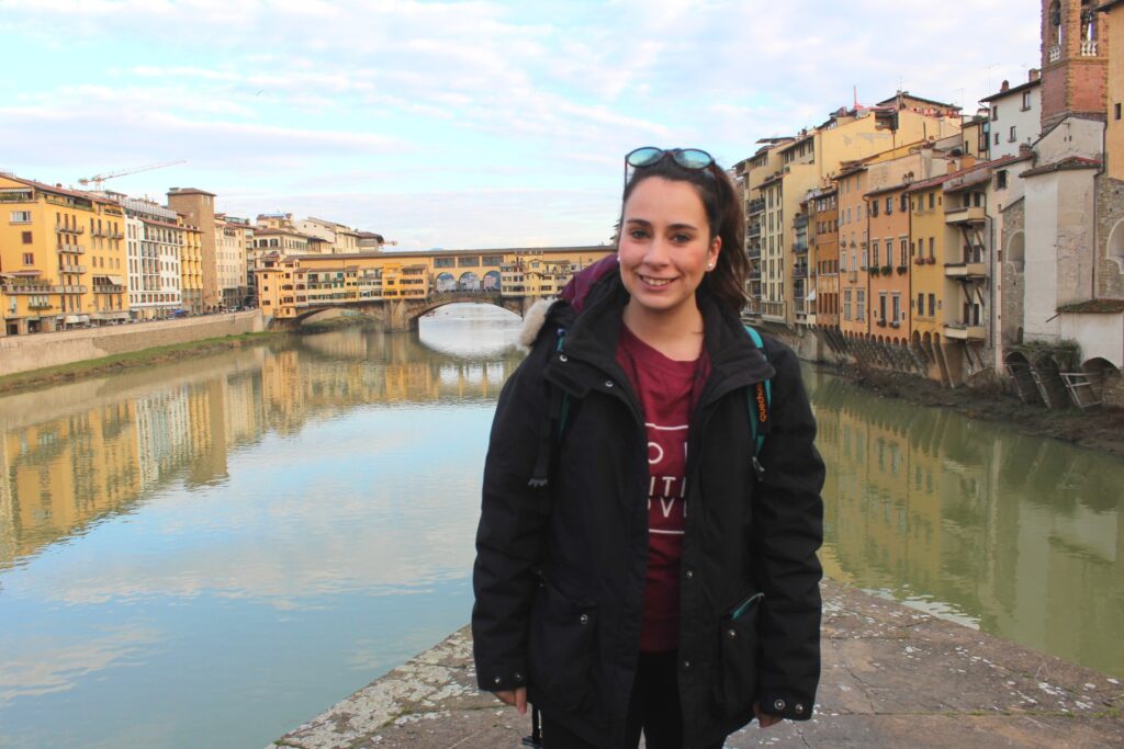 solo in florence by the river with ponte vecchio in the background