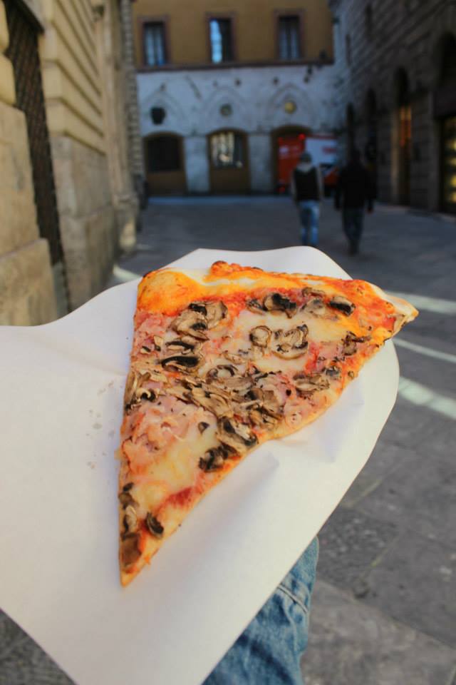 giant pizza slice in the streets of siena