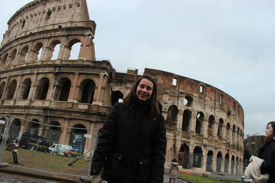 standing in from of the colosseum in Rome