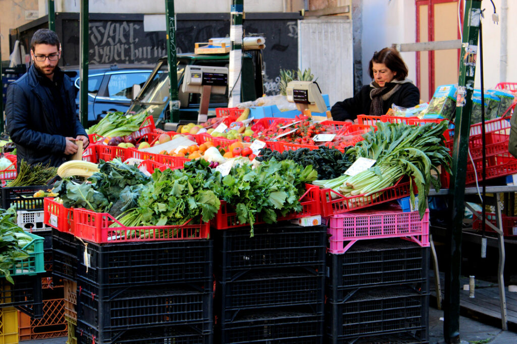 street market with fresh veggies and fruit in pisa