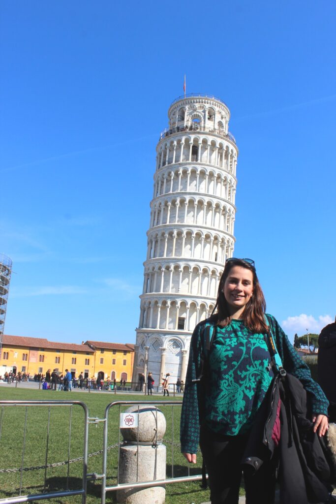 girl with the leaning tower behind her