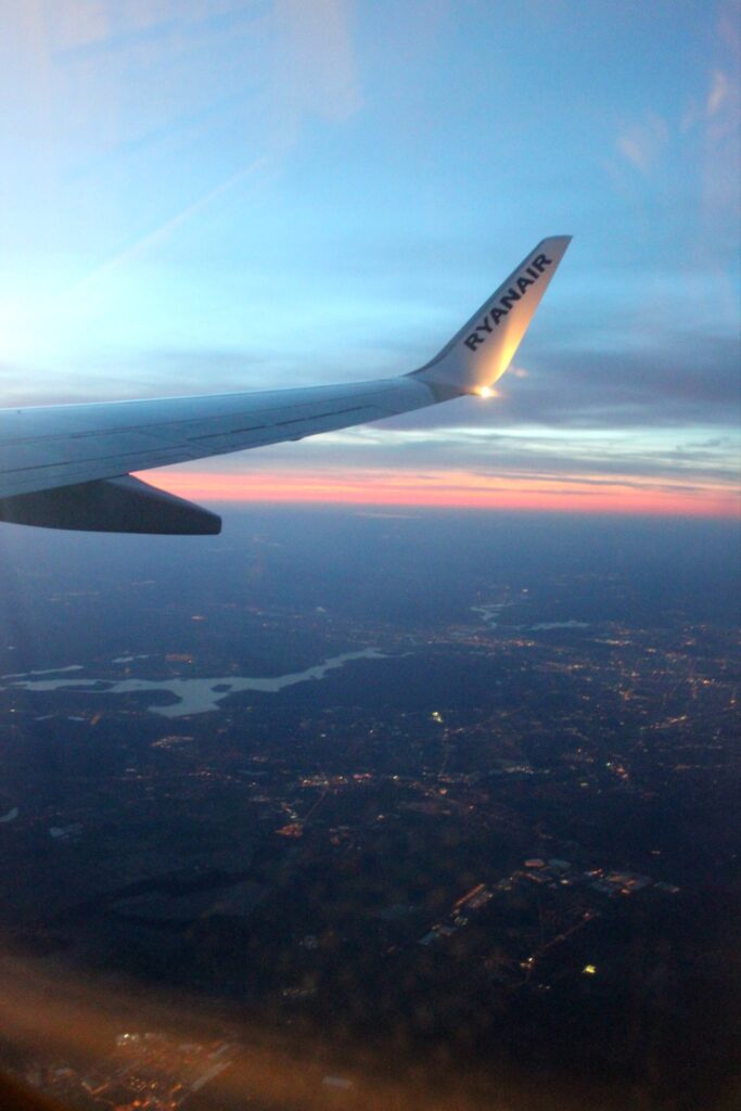 flying over germany with a pink sunset on the horizont