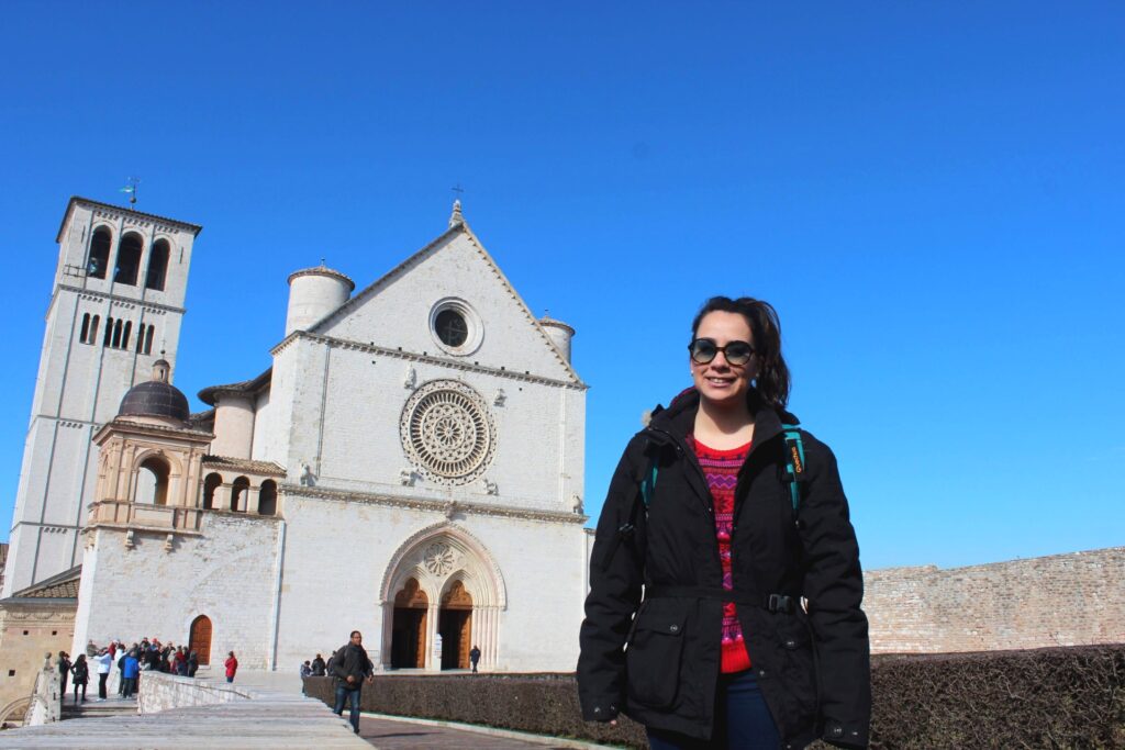 Solo female traveler in front of the Basilica of Saint Francisc of Assisi